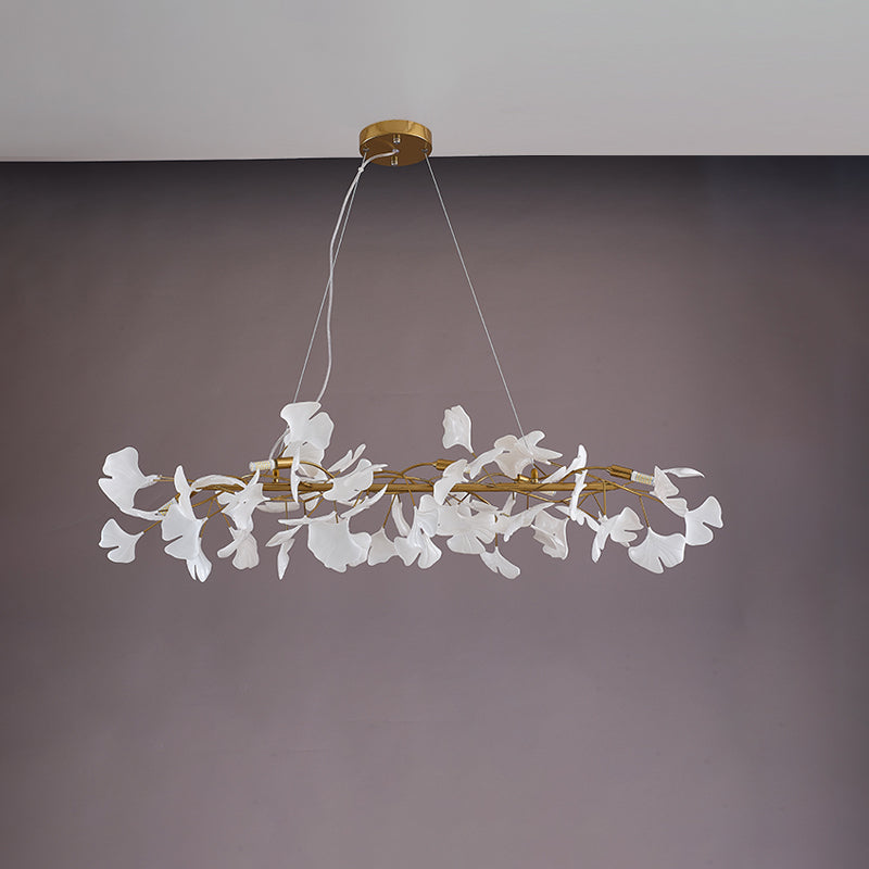 Gold 59-inch ceramic ginkgo leaf linear chandelier shown unlit.