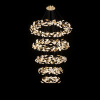 Five-tier ginkgo chandelier creating a tall cascade of white leaf shades and reflective gold leaves.