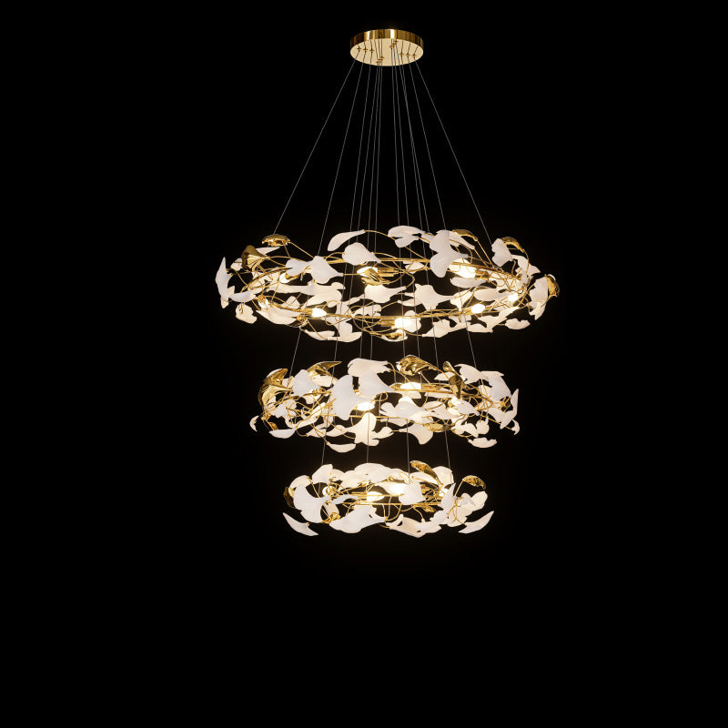Three-tier circular ginkgo chandelier with layered white leaves and reflective gold accents.