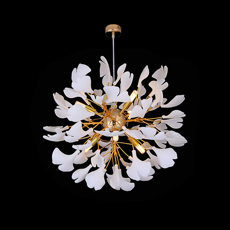 Front view of the Ø60cm all-white ginkgo leaf chandelier, hanging on a gold canopy against a black background.