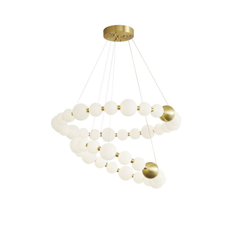 Two-tier 41- and 33-inch chandelier layers glowing pearl strands at different levels, creating a dramatic jewelry-inspired statement with visual depth.
