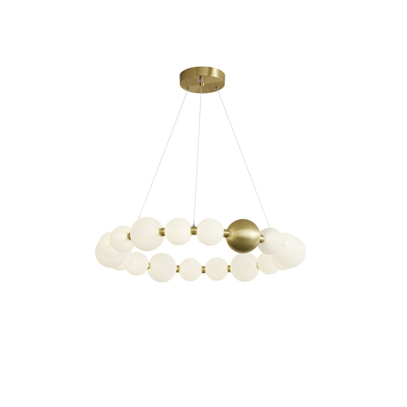 The 26-inch chandelier expands the luminous pearl circle while maintaining a balanced, visually light profile around its signature gold sphere.