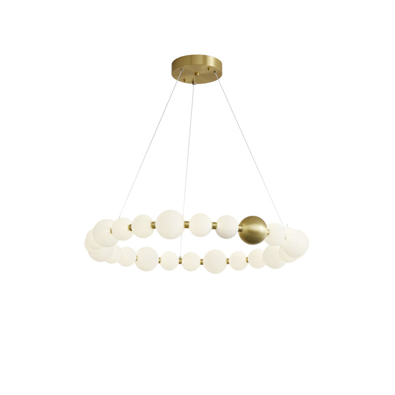 The 33-inch chandelier creates a broad, uninterrupted circle of pearl-like light, balancing statement size with an open suspended silhouette.