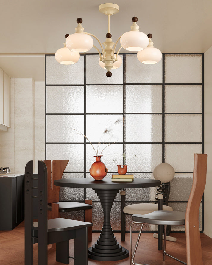 Five-light beige glass globe chandelier over a round dining table