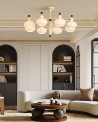 Beige eight-light chandelier with rounded glass globes in a modern living room