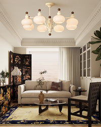 Beige glass globe chandelier above a sofa in a bright living room