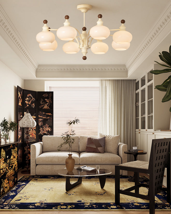 Beige glass globe chandelier above a sofa in a bright living room