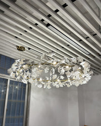 Illuminated WM2414 round chandelier viewed from below near a window.