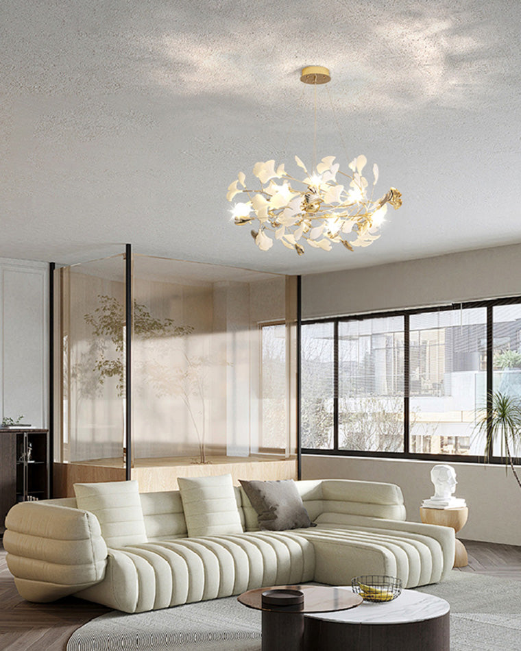 Round ceramic leaf chandelier in a bright living room with a curved white sectional.
