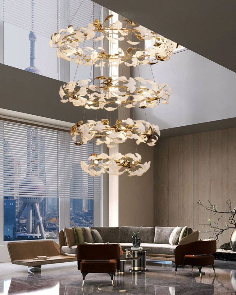 Illuminated high ceiling chandelier cascading through a double-height living room with city views.