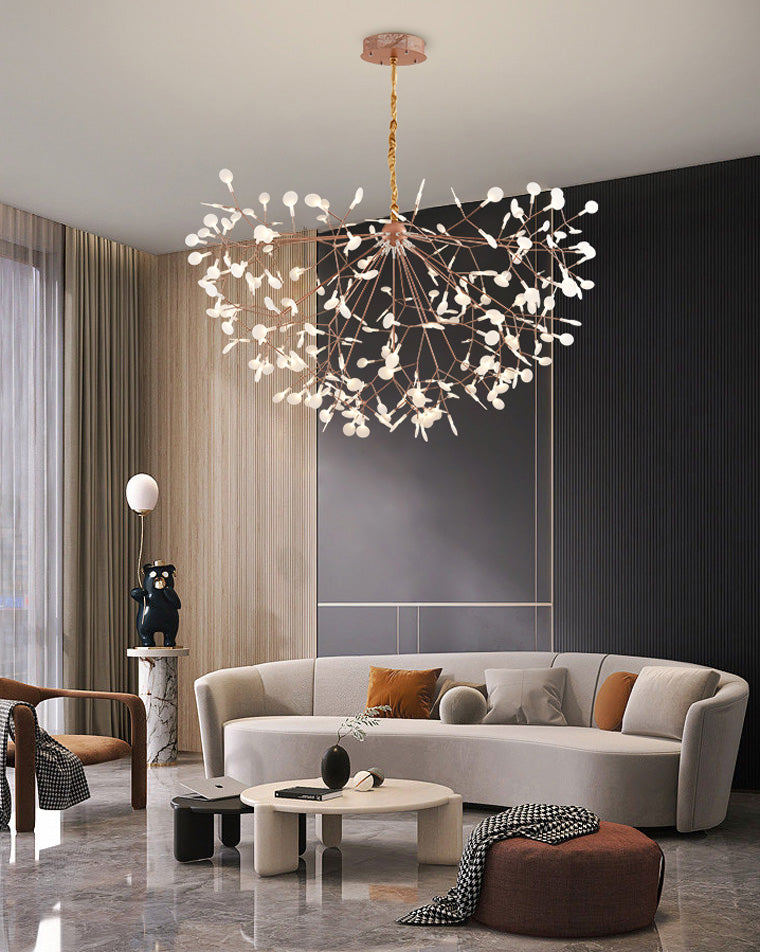 Wide rose-gold sculptural chandelier anchoring a neutral contemporary living room with graceful scale, movement, and warm illumination.