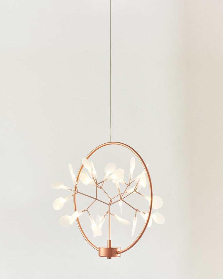 Rose-gold modern organic chandelier shown from an angled side view, revealing the visual depth created by its circular frame and branching interior.