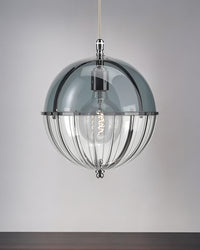 Blue glass globe pendant light with an open lower frame shown against a gray wall.