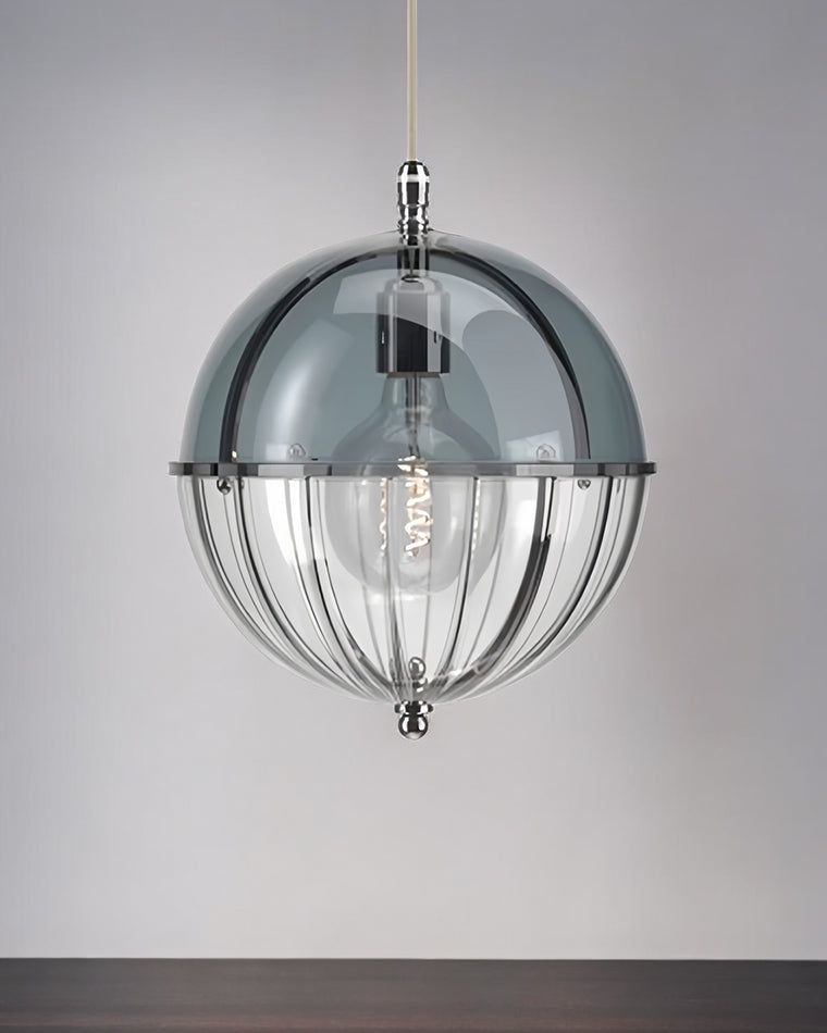 Blue glass globe pendant light with an open lower frame shown against a gray wall.