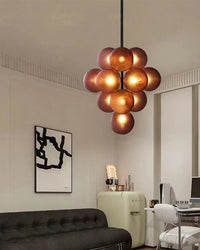 Purple glass grape chandelier adding a sculptural focal point to a contemporary living room.