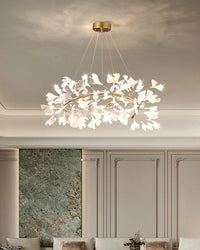 Round ceramic leaf chandelier above neutral seating in a paneled contemporary living room.