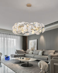 WM2419 round chandelier above a gray sectional, balancing warm light and white ceramic leaves in a contemporary living room.