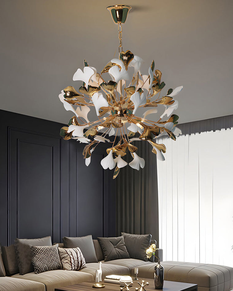 Close-up of a contemporary living room with a beige sectional sofa; above is a white and gold ginkgo leaf chandelier shown in detail.