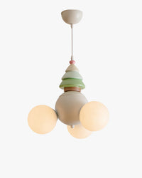 WOMO WM3130 tree-inspired globe pendant light with three glowing white globes, a rounded cream body, pastel green eco-resin tiers and a small pink accent on white.