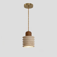 A mini pendant lamp with a ribbed travertine shade, walnut wood top and warm downward glow on a clean gray background.
