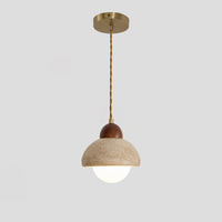 A globe pendant light with a travertine dome, walnut cap and glowing white glass sphere, suspended from a brass-tone canopy.
