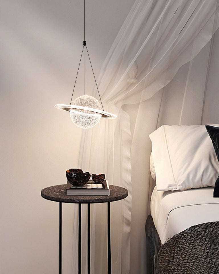 Sculptural modern globe pendant light floating beside a white canopy bed and black round side table.