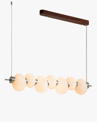 WOMO WM3145 seven-ring linear chandelier with alternating ribbed glass discs, a silver-toned rail, twin suspension cables and a dark wood-grain canopy on white.