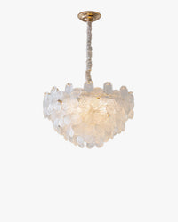 Clear glass flower pendant light with layered ribbed petals, a gold-tone ceiling canopy and a softly glowing bouquet shape.