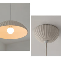 Split close-up of the dome pendant light, showing the illuminated exposed bulb beneath the open shade and radiating folds on the matching canopy.