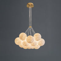 Full view of the thirteen-light cluster globe chandelier on a dark grey background, showing the wider cloud-like arrangement and gold-toned canopy.
