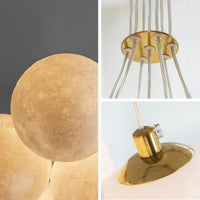 Detail collage of the PLA globe chandelier, showing the moon-like shade texture, gold-toned cable hub and metal shade connector.