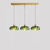 White-background view of a 30-inch linear chandelier with three matching green petal glass shades suspended from a long metal canopy.