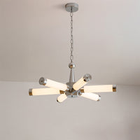 Full view of a radial chrome mid century modern chandelier mounted beneath a white ceiling.