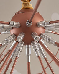 Close-up of the rose-gold central hub and radiating metal arms, revealing the engineered structure behind the chandelier’s weightless silhouette.