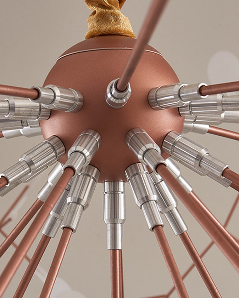 Close-up of the rose-gold central hub and radiating metal arms, revealing the engineered structure behind the chandelier’s weightless silhouette.