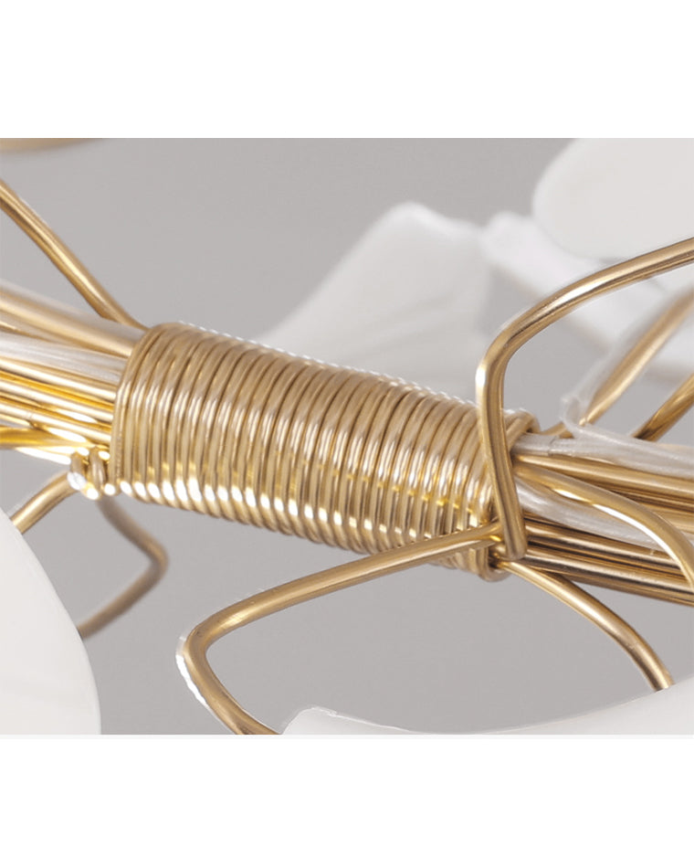 Close-up of the WM2419 chandelier’s bundled gold-toned branches, showing the sculptural framework beneath the ceramic leaf canopy.