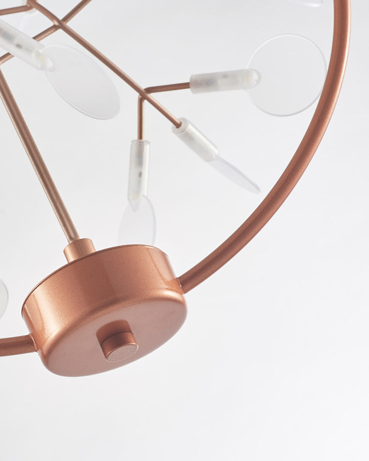 Rose-gold ring and lower housing detail, showing how the compact dining light fixture balances practical illumination with a jewelry-like finish.