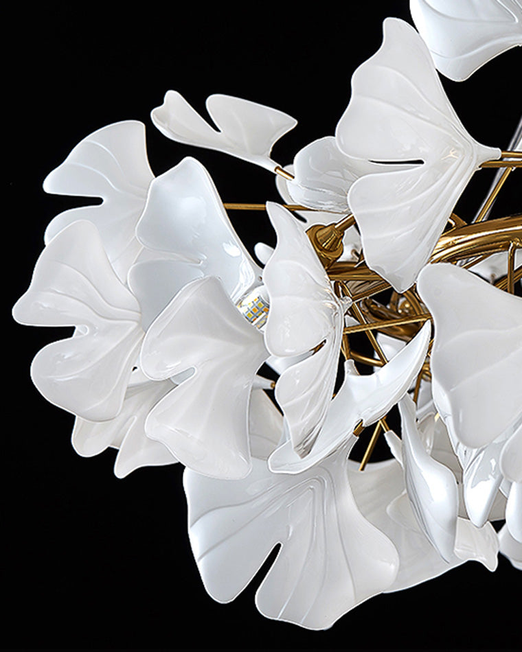 Close-up of sculpted white ceramic ginkgo leaves surrounding the LED light source.