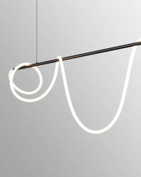 Close view of a matte-black LED linear chandelier with the illuminated silicone rope wrapped into loose loops around the suspended bar.
