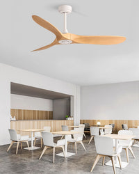 A light-wood wooden ceiling fan brings natural warmth to this airy, minimalist dining space.