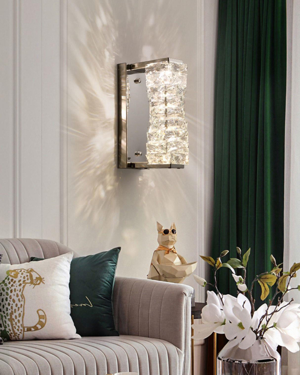 Chrome crystal wall sconce above a sofa, adding sparkling ambient wall light to a living room corner