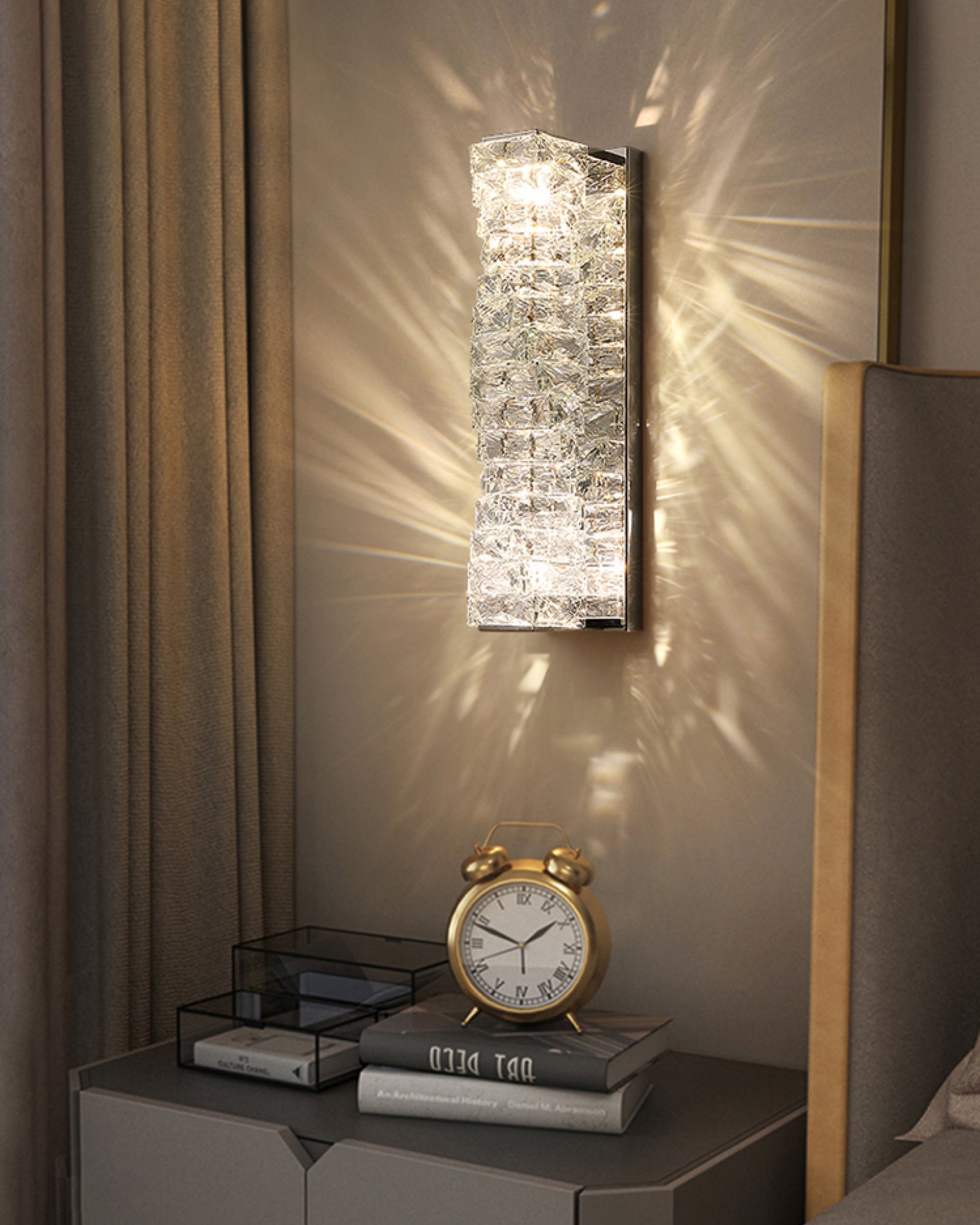 Chrome crystal wall sconce above a bedside table, showing sparkling wall wash and compact placement