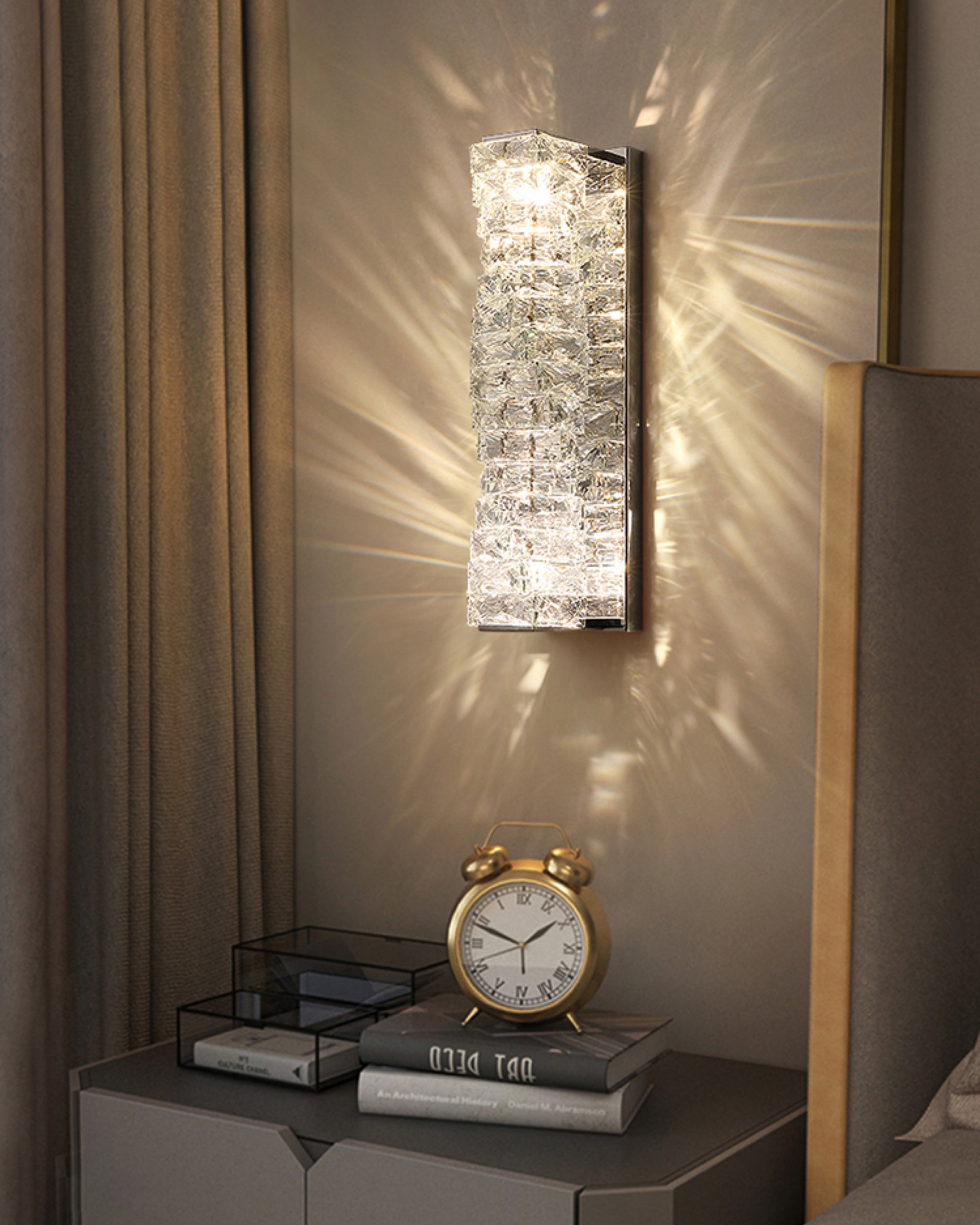 Chrome crystal wall sconce above a bedside table, showing sparkling wall wash and compact placement