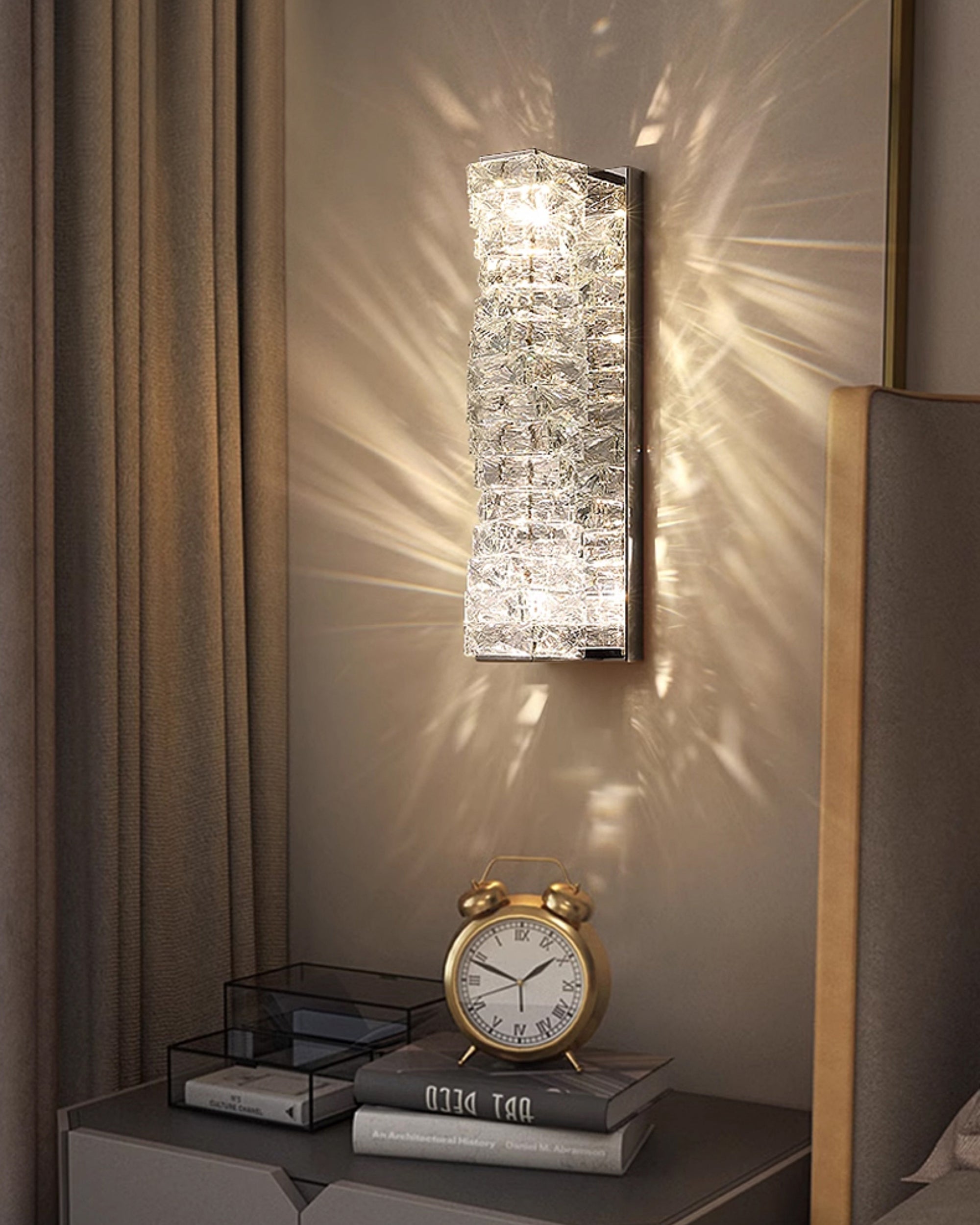 Crystal wall sconce in chrome finish mounted on paneled wall, creating a soft decorative glow