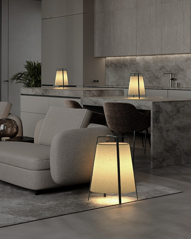 Three paper lantern floor lamps creating soft ambient light across an open-plan living and dining space.