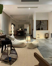 Low paper lantern lamps used in multiple seating zones of an open living area.