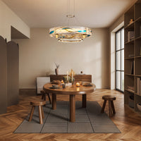 Enamel round brass chandelier above a round wood dining table, adding warm ambient light and decorative depth to a contemporary dining space.