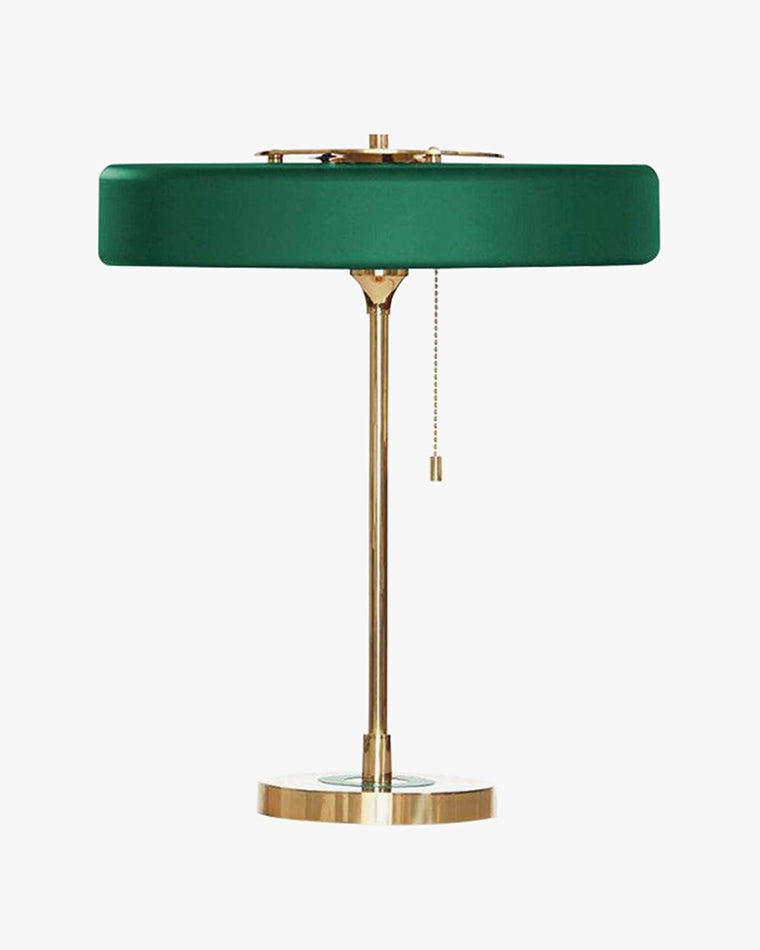 Green pull chain lamp with a shallow round metal shade, slim gold-tone frame and circular base on white.