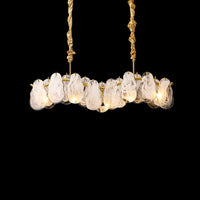 Illuminated 31-inch cloud chandelier with layered white-swirled glass pieces arranged along a softly undulating gold frame against a black background.