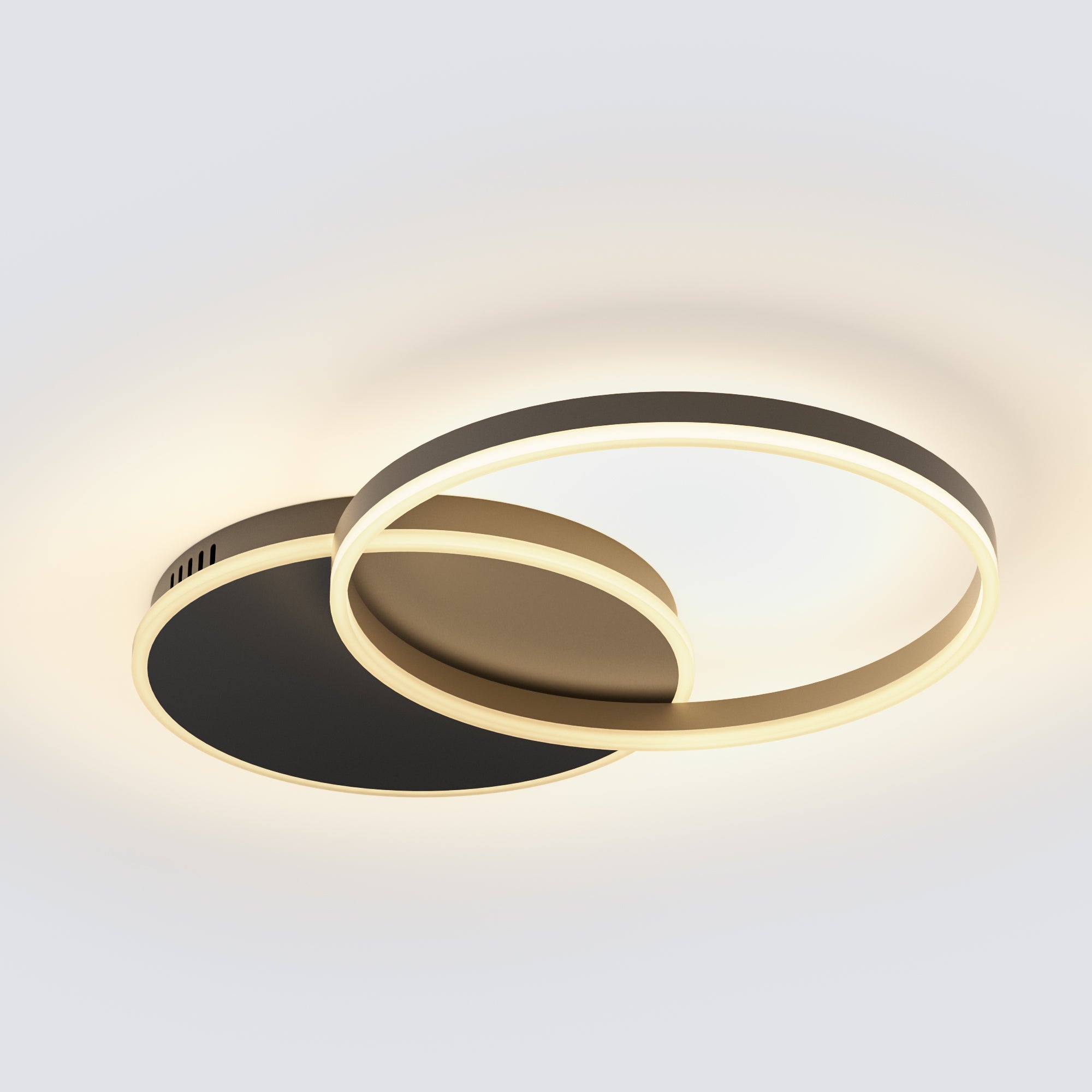 A black-and-gold circular light with overlapping rings and warm LED glow, creating a sleek contrast for contemporary ceilings.